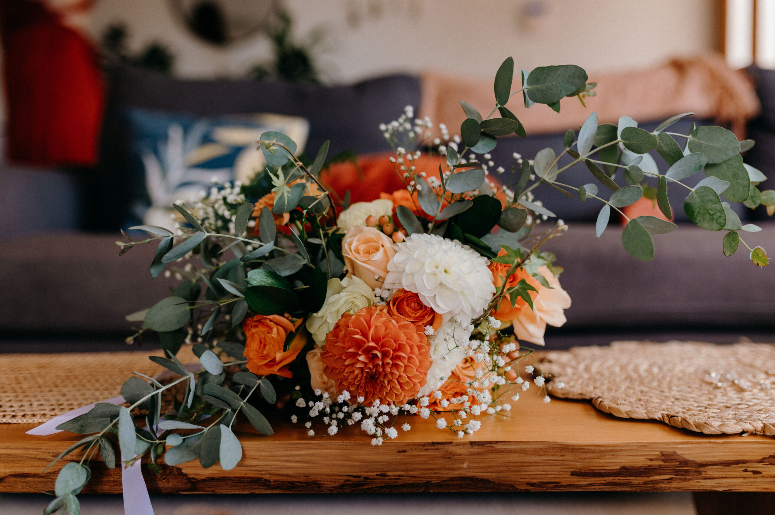 Eucalyptus and hypericum berries laid along a green linen runner